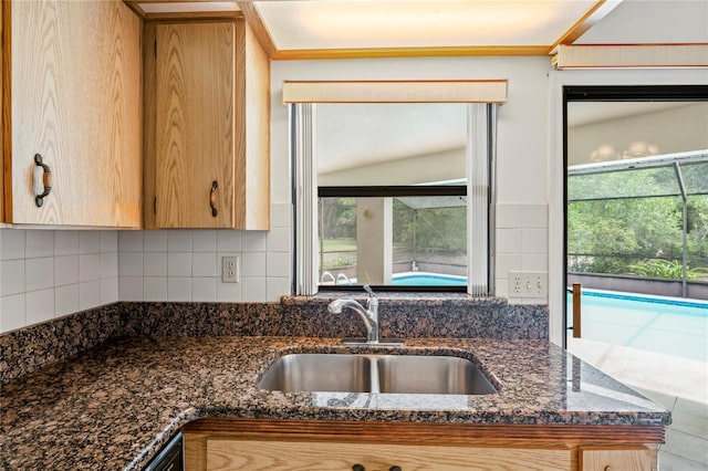128 Oak Lake Dr, Spring Hill, FL 34608 - kitchen with a sink, decorative backsplash, and dark stone counters