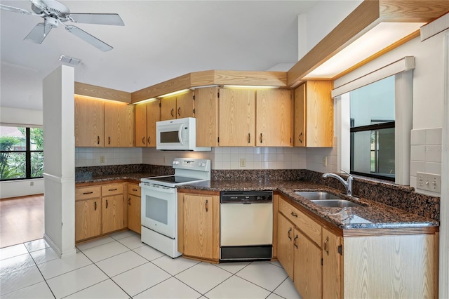 128 Oak Lake Dr, Spring Hill, FL 34608 - kitchen with white appliances, decorative backsplash, dark stone counters, a sink, and a ceiling fan