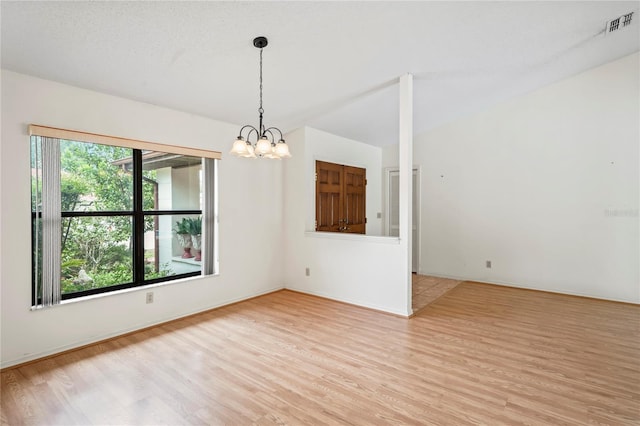 128 Oak Lake Dr, Spring Hill, FL 34608 - spare room with plenty of natural light, light wood-style floors, and a chandelier