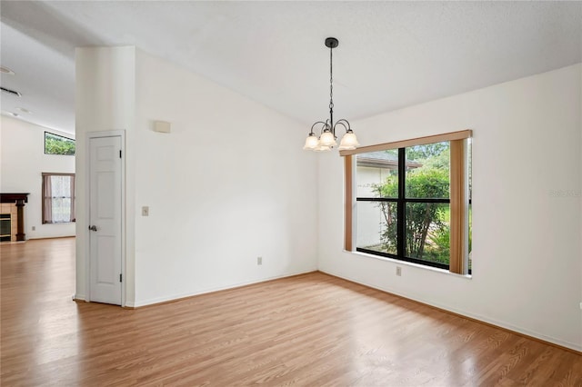 128 Oak Lake Dr, Spring Hill, FL 34608 - empty room with light wood-style flooring, a chandelier, and baseboards