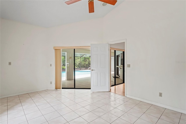 128 Oak Lake Dr, Spring Hill, FL 34608 - spare room featuring a ceiling fan, baseboards, and high vaulted ceiling