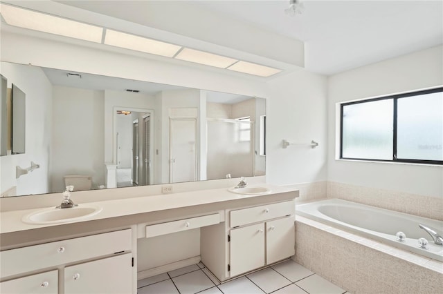 128 Oak Lake Dr, Spring Hill, FL 34608 - full bath featuring double vanity, a stall shower, a garden tub, and tile patterned flooring