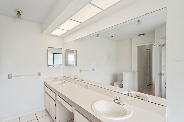 128 Oak Lake Dr, Spring Hill, FL 34608 - full bath with tile patterned floors, double vanity, toilet, and baseboards