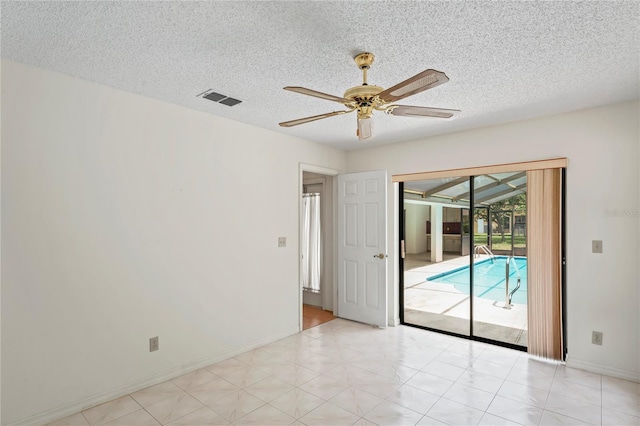 128 Oak Lake Dr, Spring Hill, FL 34608 - spare room featuring a ceiling fan, baseboards, a textured ceiling, and light floors