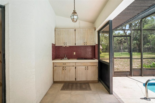 128 Oak Lake Dr, Spring Hill, FL 34608 - kitchen featuring light countertops, light brown cabinets, vaulted ceiling, backsplash, and light tile patterned floors