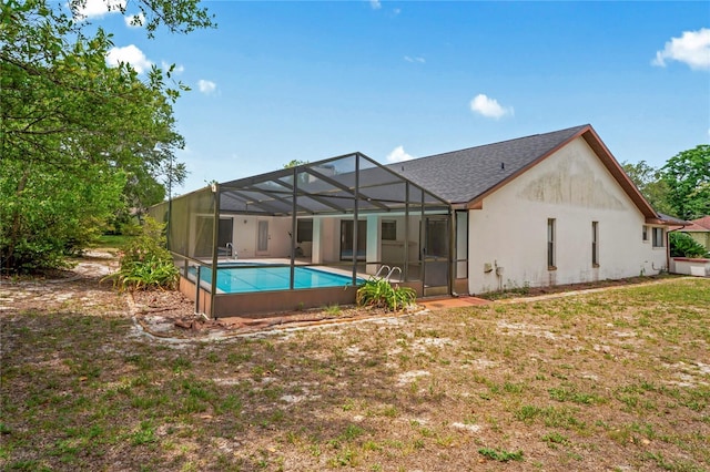 128 Oak Lake Dr, Spring Hill, FL 34608 - back of house with an outdoor pool, glass enclosure, and a patio area