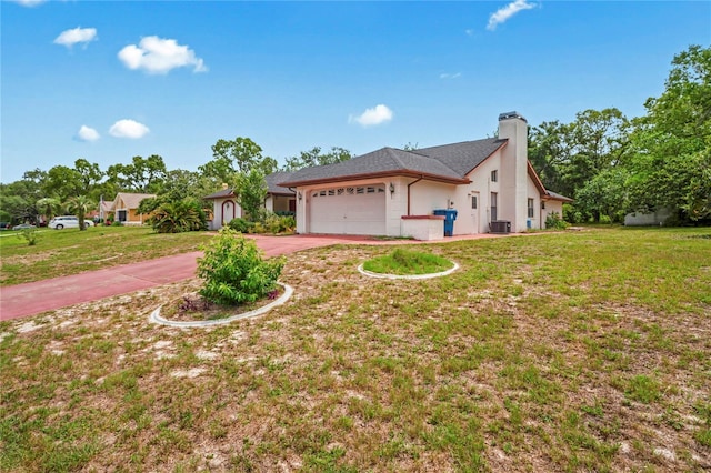 128 Oak Lake Dr, Spring Hill, FL 34608 - single story home featuring an attached garage, driveway, a chimney, and a front yard