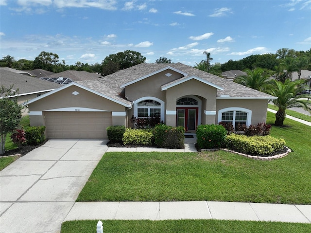 22316 Red Jacket Ln, Land O Lakes, FL 34639 - ranch-style home featuring stucco siding, a front lawn, a garage, driveway, and roof with shingles