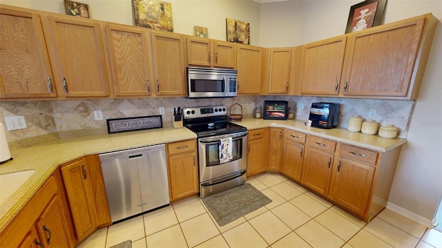22316 Red Jacket Ln, Land O Lakes, FL 34639 - kitchen with stainless steel appliances, light countertops, tasteful backsplash, and light tile patterned flooring