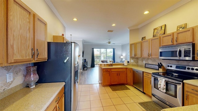 22316 Red Jacket Ln, Land O Lakes, FL 34639 - kitchen with stainless steel appliances, crown molding, light countertops, recessed lighting, and tasteful backsplash