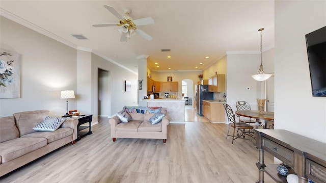 22316 Red Jacket Ln, Land O Lakes, FL 34639 - living area featuring light wood finished floors, crown molding, arched walkways, a ceiling fan, and baseboards
