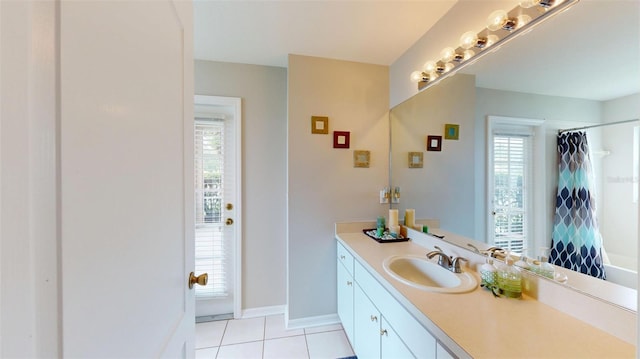 22316 Red Jacket Ln, Land O Lakes, FL 34639 - bathroom with vanity, tile patterned floors, healthy amount of natural light, and baseboards