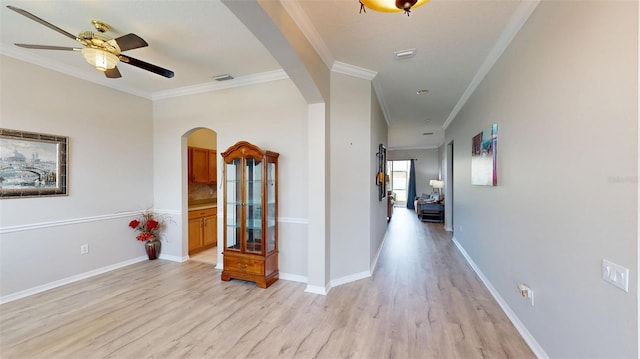 22316 Red Jacket Ln, Land O Lakes, FL 34639 - hallway with arched walkways, light wood finished floors, ornamental molding, and baseboards