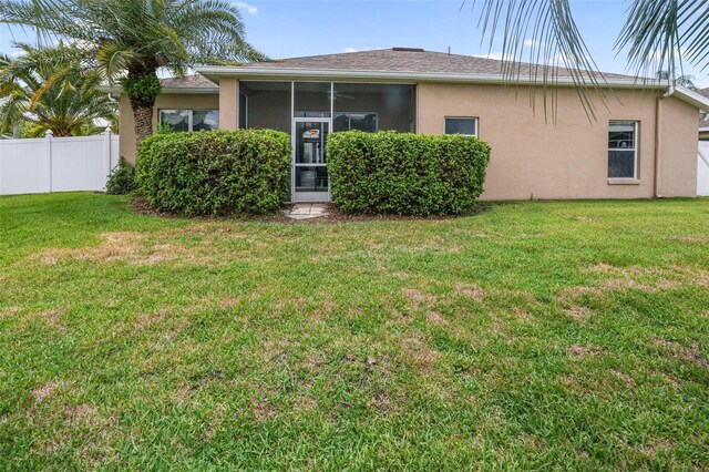 22316 Red Jacket Ln, Land O Lakes, FL 34639 - rear view of house with stucco siding and a sunroom