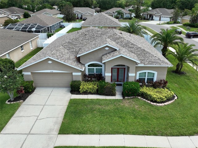 22316 Red Jacket Ln, Land O Lakes, FL 34639 - ranch-style house featuring stucco siding, a garage, driveway, and a front lawn