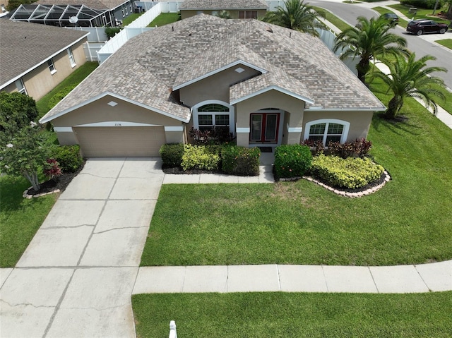 22316 Red Jacket Ln, Land O Lakes, FL 34639 - view of front of property featuring stucco siding, an attached garage, a front lawn, and driveway
