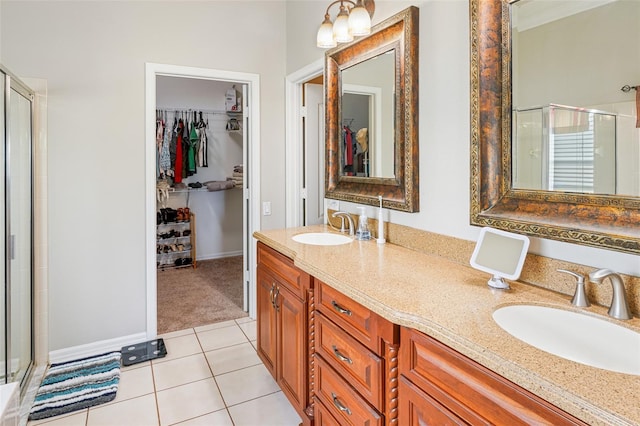 22316 Red Jacket Ln, Land O Lakes, FL 34639 - bathroom with a shower stall, a spacious closet, double vanity, and tile patterned flooring