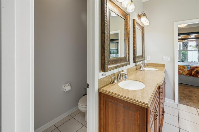 22316 Red Jacket Ln, Land O Lakes, FL 34639 - ensuite bathroom with tile patterned floors, double vanity, toilet, and baseboards