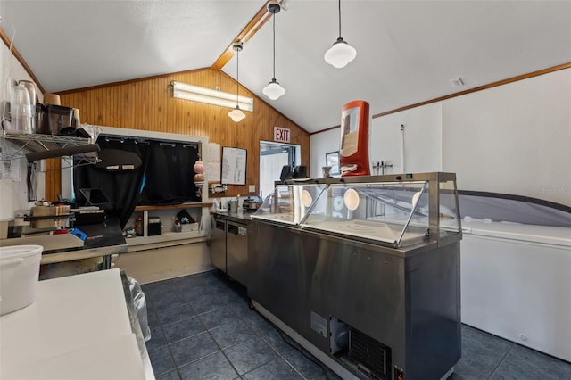 10844 W Yulee Dr, Homosassa, FL 34448 - kitchen with lofted ceiling, wooden walls, dark tile patterned flooring, and decorative light fixtures