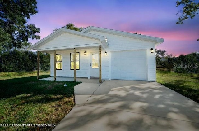 3554 Arrowhead Ave, Spring Hill, FL 34606 - ranch-style home featuring a porch, driveway, an attached garage, and a lawn