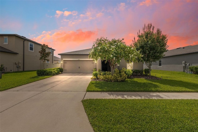 12313 Criollo Rd, Spring Hill, FL 34610 - view of front of home with concrete driveway, a garage, a front lawn, and stucco siding
