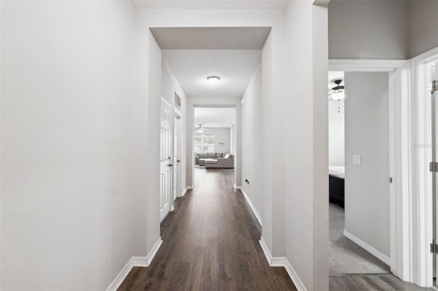 12313 Criollo Rd, Spring Hill, FL 34610 - hall featuring dark wood-type flooring and baseboards