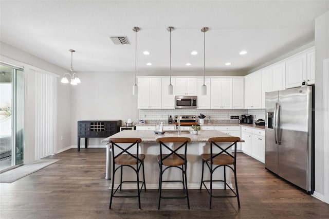12313 Criollo Rd, Spring Hill, FL 34610 - kitchen with stainless steel appliances, dark wood finished floors, backsplash, and recessed lighting