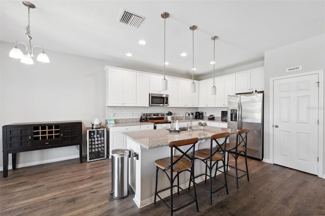 12313 Criollo Rd, Spring Hill, FL 34610 - kitchen featuring stainless steel appliances, dark wood-style floors, decorative backsplash, white cabinetry, and recessed lighting