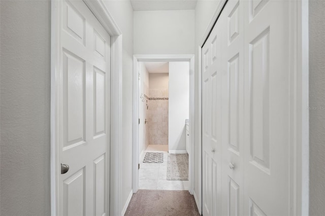 12313 Criollo Rd, Spring Hill, FL 34610 - hall with carpet floors, tile patterned floors, and baseboards