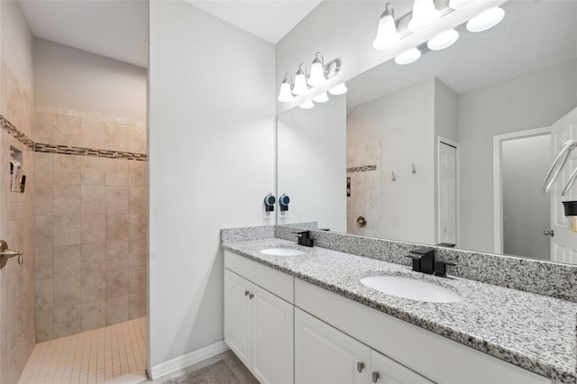 12313 Criollo Rd, Spring Hill, FL 34610 - bathroom with double vanity, tiled shower, baseboards, and tile patterned floors