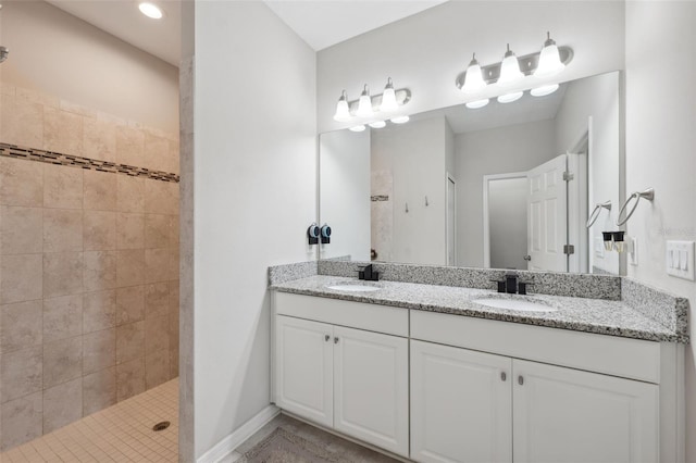 12313 Criollo Rd, Spring Hill, FL 34610 - bathroom with double vanity, tiled shower, and baseboards