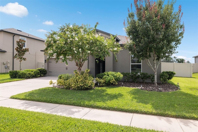 12313 Criollo Rd, Spring Hill, FL 34610 - view of property hidden behind natural elements featuring stucco siding, concrete driveway, and a garage