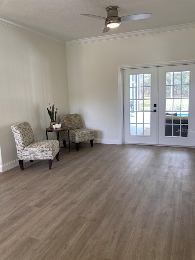 2543 E Marcia St, Inverness, FL 34453 - living area with ornamental molding, wood finished floors, ceiling fan, baseboards, and a textured ceiling