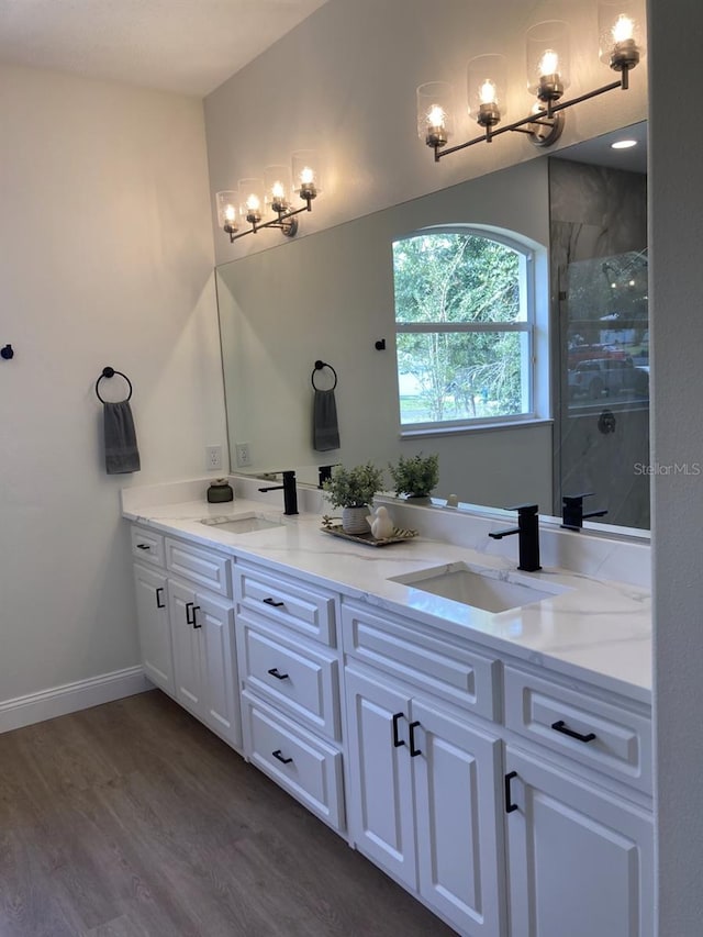 2543 E Marcia St, Inverness, FL 34453 - full bathroom featuring a chandelier, double vanity, wood finished floors, a shower stall, and baseboards