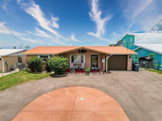 6601 Nautical Isle, Hudson, FL 34667 - single story home with driveway, a gate, a garage, metal roof, and covered porch