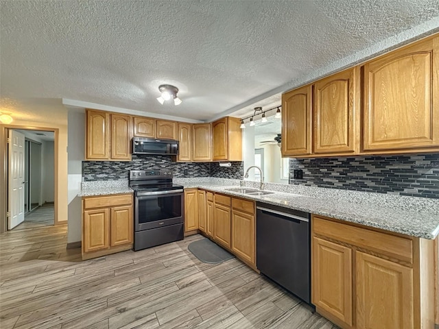 6601 Nautical Isle, Hudson, FL 34667 - kitchen featuring stainless steel range with electric cooktop, dishwasher, black microwave, a sink, and a textured ceiling