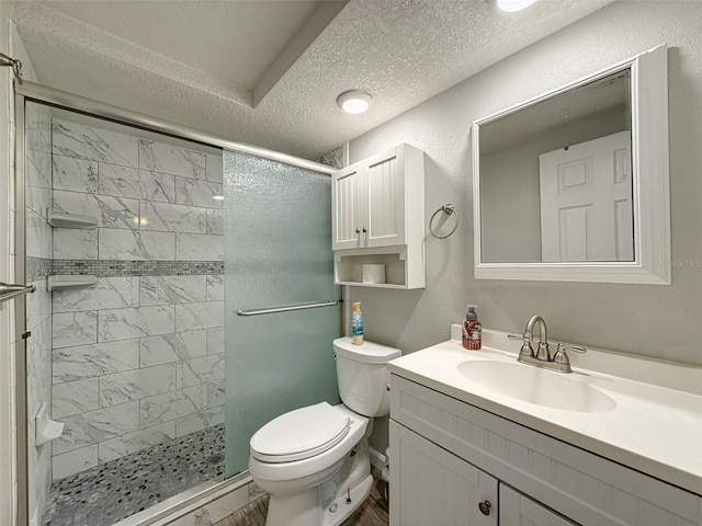6601 Nautical Isle, Hudson, FL 34667 - bathroom featuring a textured ceiling, toilet, a stall shower, and vanity