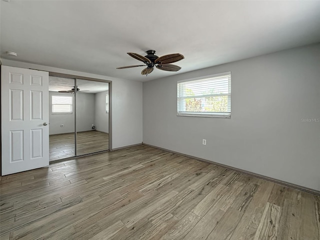 6601 Nautical Isle, Hudson, FL 34667 - unfurnished bedroom with wood finished floors, a closet, ceiling fan, and baseboards