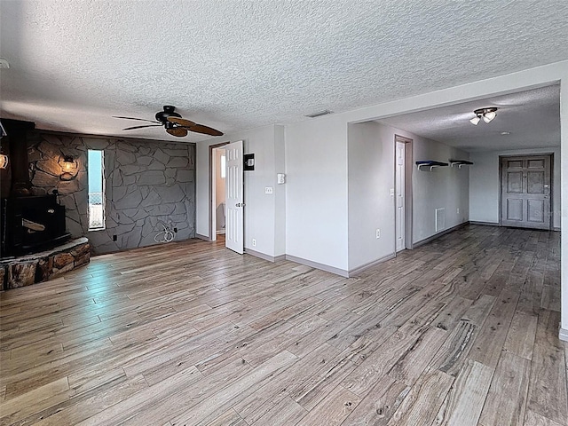 6601 Nautical Isle, Hudson, FL 34667 - unfurnished living room featuring wood finished floors, ceiling fan, a textured ceiling, and baseboards