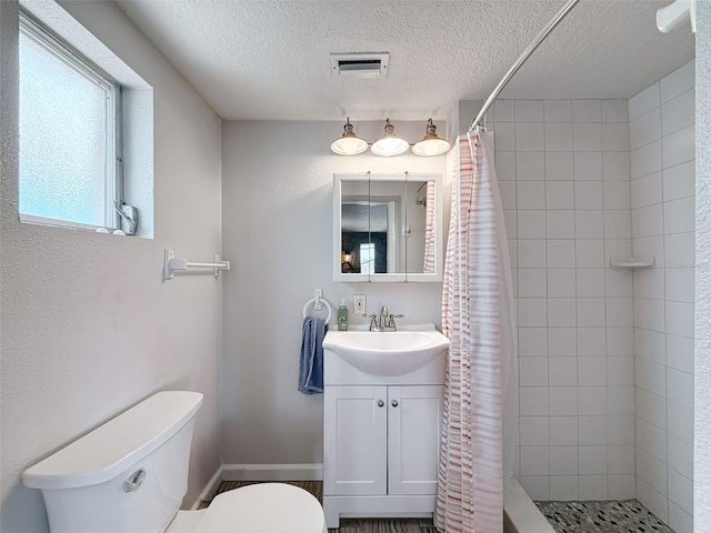 6601 Nautical Isle, Hudson, FL 34667 - full bathroom with toilet, a tile shower, vanity, and a textured ceiling