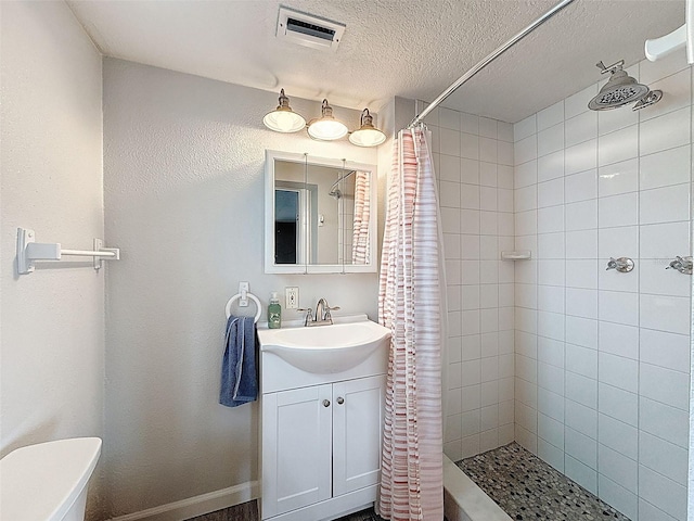 6601 Nautical Isle, Hudson, FL 34667 - full bath with tiled shower, vanity, toilet, and a textured ceiling