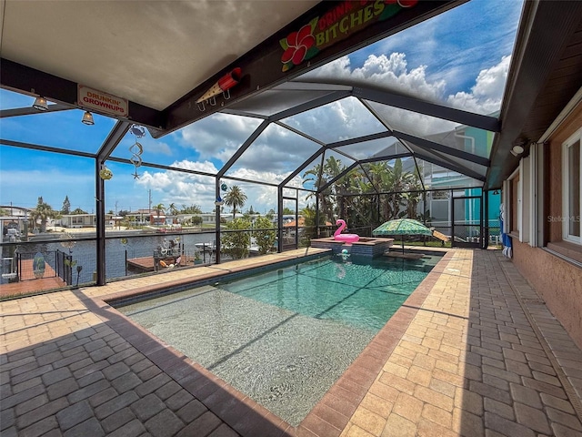 6601 Nautical Isle, Hudson, FL 34667 - view of swimming pool with a water view, a patio, glass enclosure, and a pool with connected hot tub