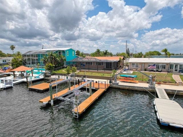6601 Nautical Isle, Hudson, FL 34667 - dock featuring a water view, boat lift, and a lawn