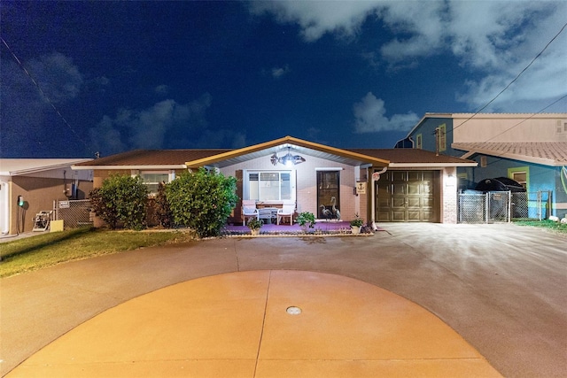 6601 Nautical Isle, Hudson, FL 34667 - view of front of house with concrete driveway, a garage, and brick siding