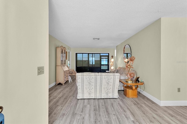 4841 Wakefield Ct Unit 4841, New Port Richey, FL 34655 - living area featuring wood finished floors, baseboards, and a textured ceiling