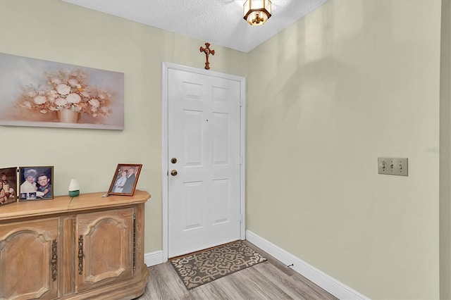 4841 Wakefield Ct Unit 4841, New Port Richey, FL 34655 - foyer with wood finished floors, baseboards, and a textured ceiling