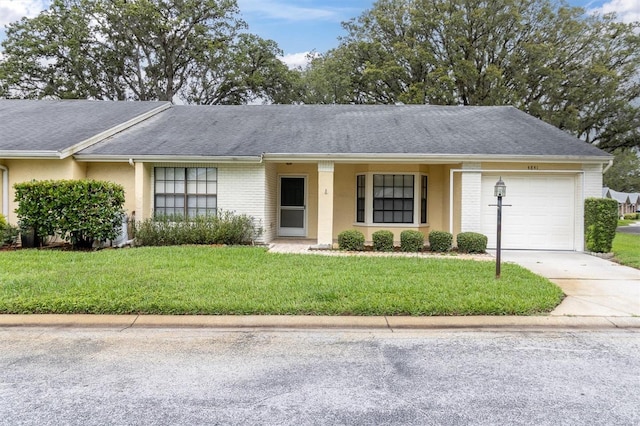 4841 Wakefield Ct Unit 4841, New Port Richey, FL 34655 - single story home featuring an attached garage, driveway, a front yard, and stucco siding