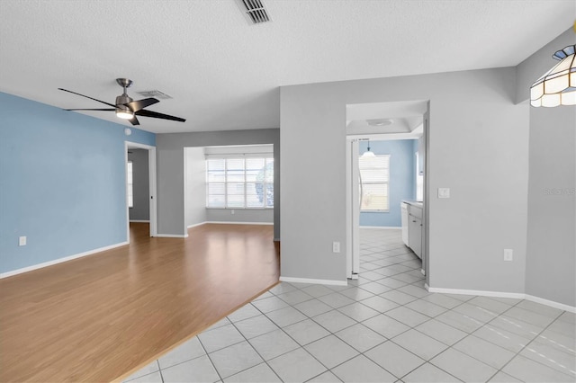 9529 Bunker Hill Ct Unit 9529, New Port Richey, FL 34655 - empty room with a textured ceiling, a ceiling fan, baseboards, and light wood-style floors