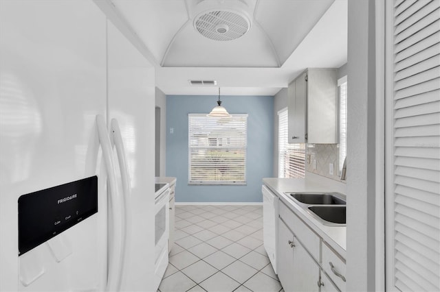 9529 Bunker Hill Ct Unit 9529, New Port Richey, FL 34655 - kitchen featuring white appliances, light countertops, baseboards, light tile patterned flooring, and pendant lighting