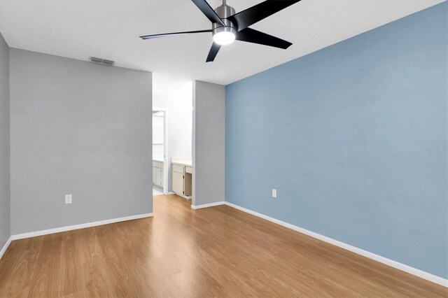 9529 Bunker Hill Ct Unit 9529, New Port Richey, FL 34655 - empty room with wood finished floors, ceiling fan, and baseboards